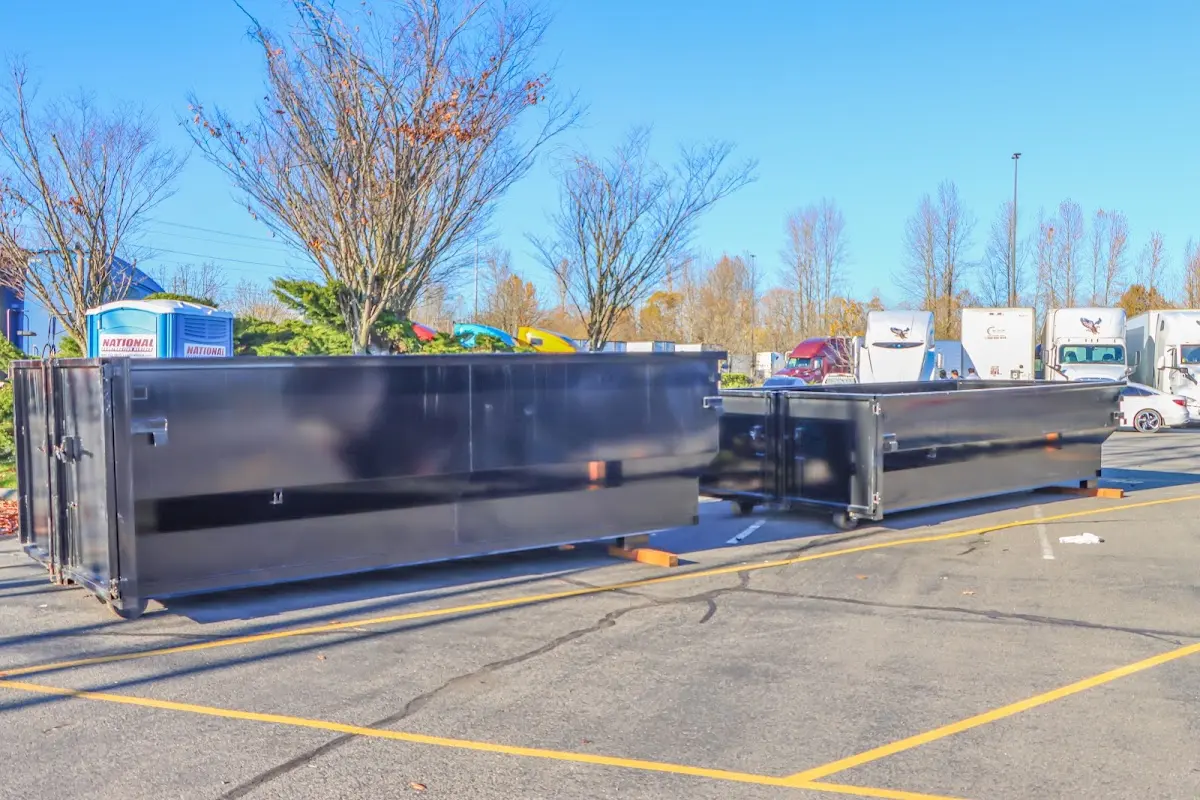 Professional dumpster rental service with roll-off container on residential driveway in Red Lion